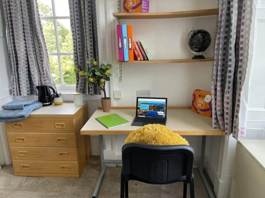 Desk with laptop files and globe study area at St Mary's Newcastle in Newcastle Upon Tyne Student Accommodation