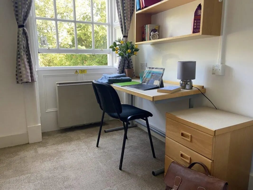 Desk with laptop and chair study area at St Mary's Newcastle in Newcastle Upon Tyne Student Accommodation