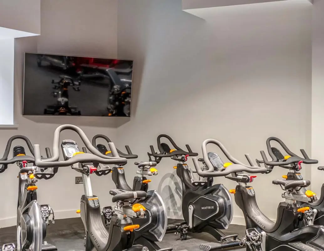 Exercise bikes and wall mounted television gym. at Gravity in Lincoln Student Accommodation