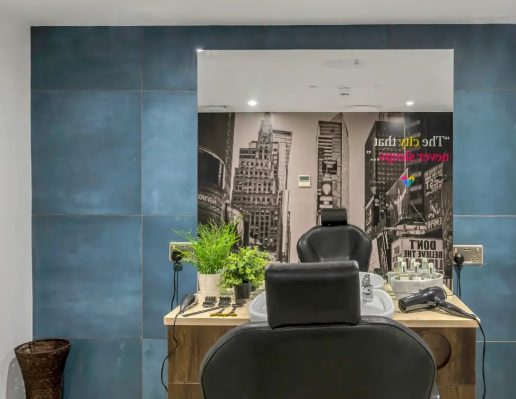 Chairs mirror city mural and haircutting tools salon at Gravity in Lincoln Student Accommodation