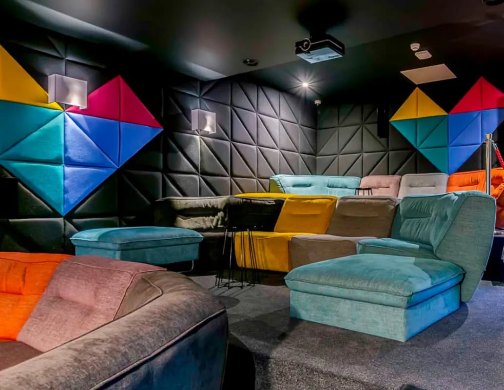 Colorful modular sofas and ottomans in a lounge at Gravity in Lincoln Student Accommodation