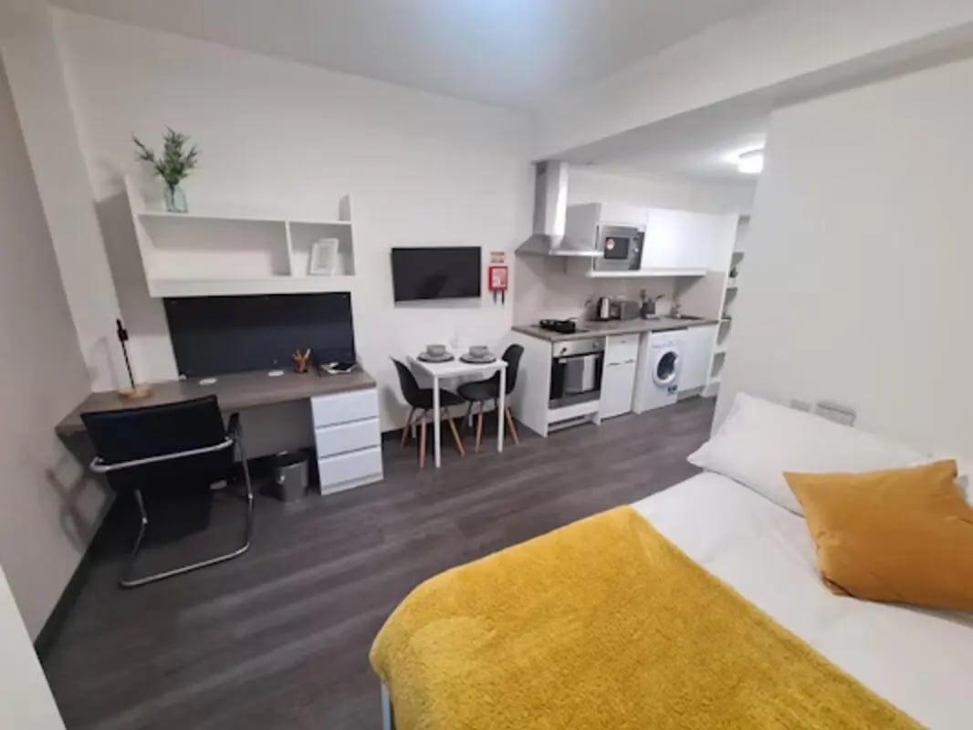 Desk bed kitchenette and dining area studio apartment at St James House in Newcastle Upon Tyne Student Accommodation