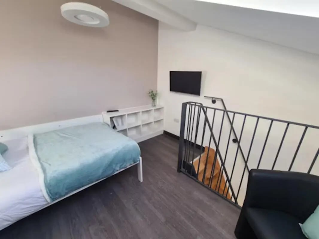 Bed shelf TV railing and sofa bedroom at St James House in Newcastle Upon Tyne Student Accommodation