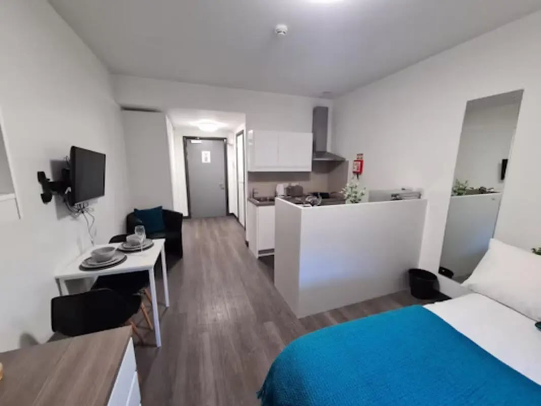 Bed table kitchen and TV studio apartment at St James House in Newcastle Upon Tyne Student Accommodation