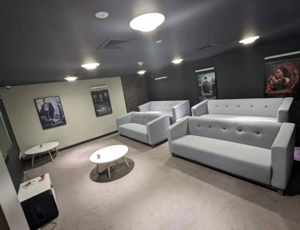 Light grey sofas and white tables living room at St James House in Newcastle Upon Tyne Student Accommodation