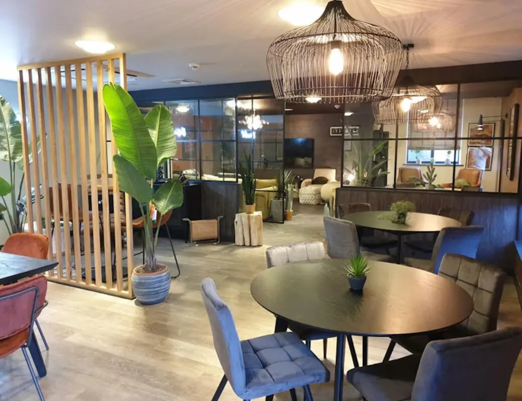 Tables chairs plants lounge area living room at St James House in Newcastle Upon Tyne Student Accommodation