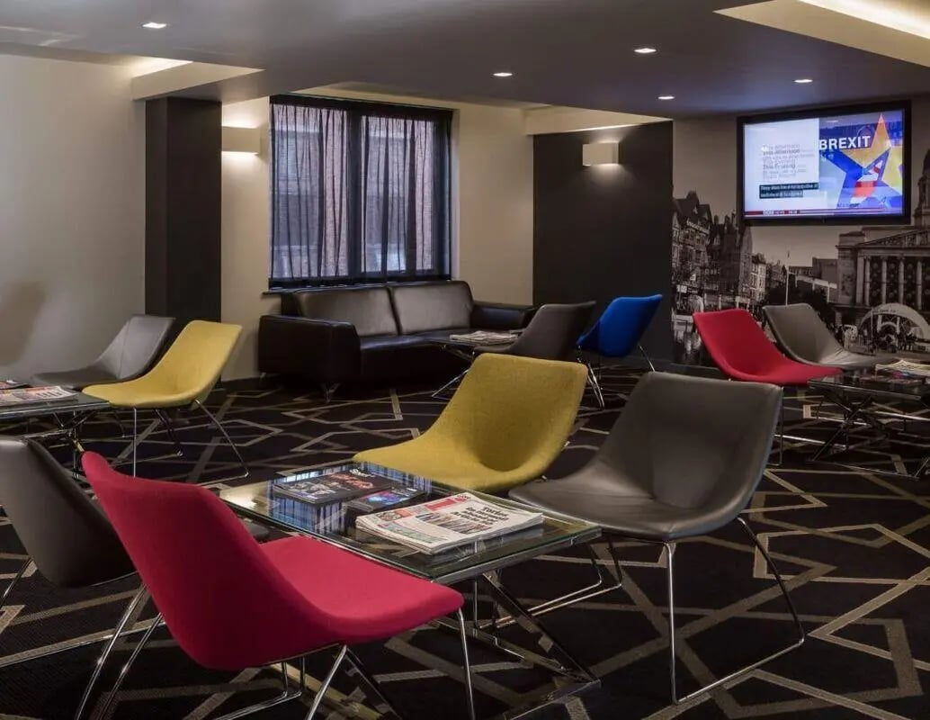 Colorful chairs and sofa in common area living room at IconInc Nottingham City in Nottingham Student Accommodation