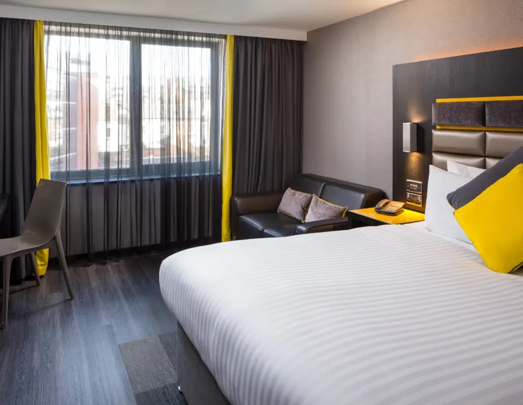 Bed sofa chair telephone window bedroom at IconInc Nottingham City in Nottingham Student Accommodation