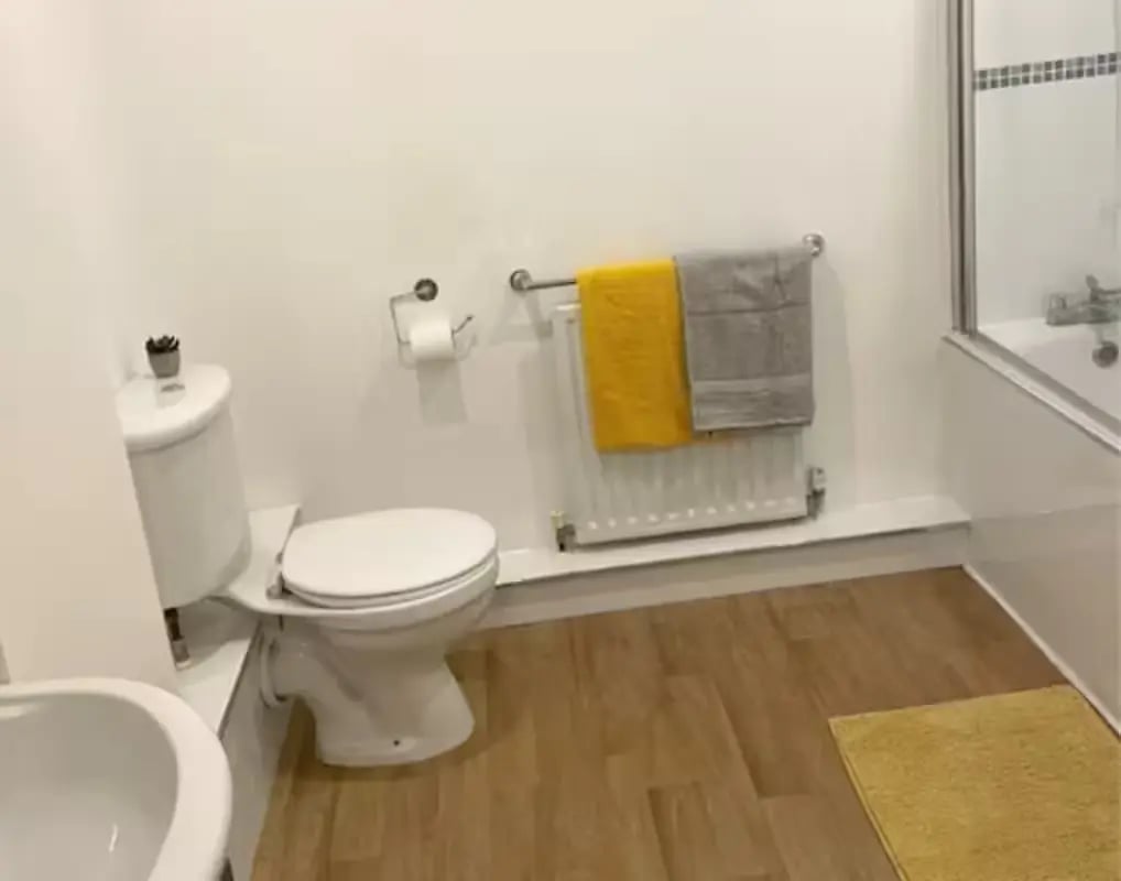 Toilet radiator towels and bath exterior at Page Apartments @ Central Place in Sheffield Student Accommodation