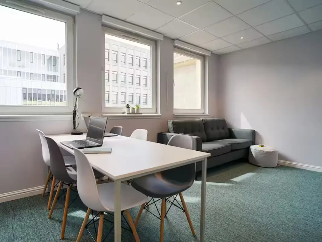 Table chairs laptop couch and ottoman lounge area at 8 Roxburgh in Edinburgh Student Accommodation