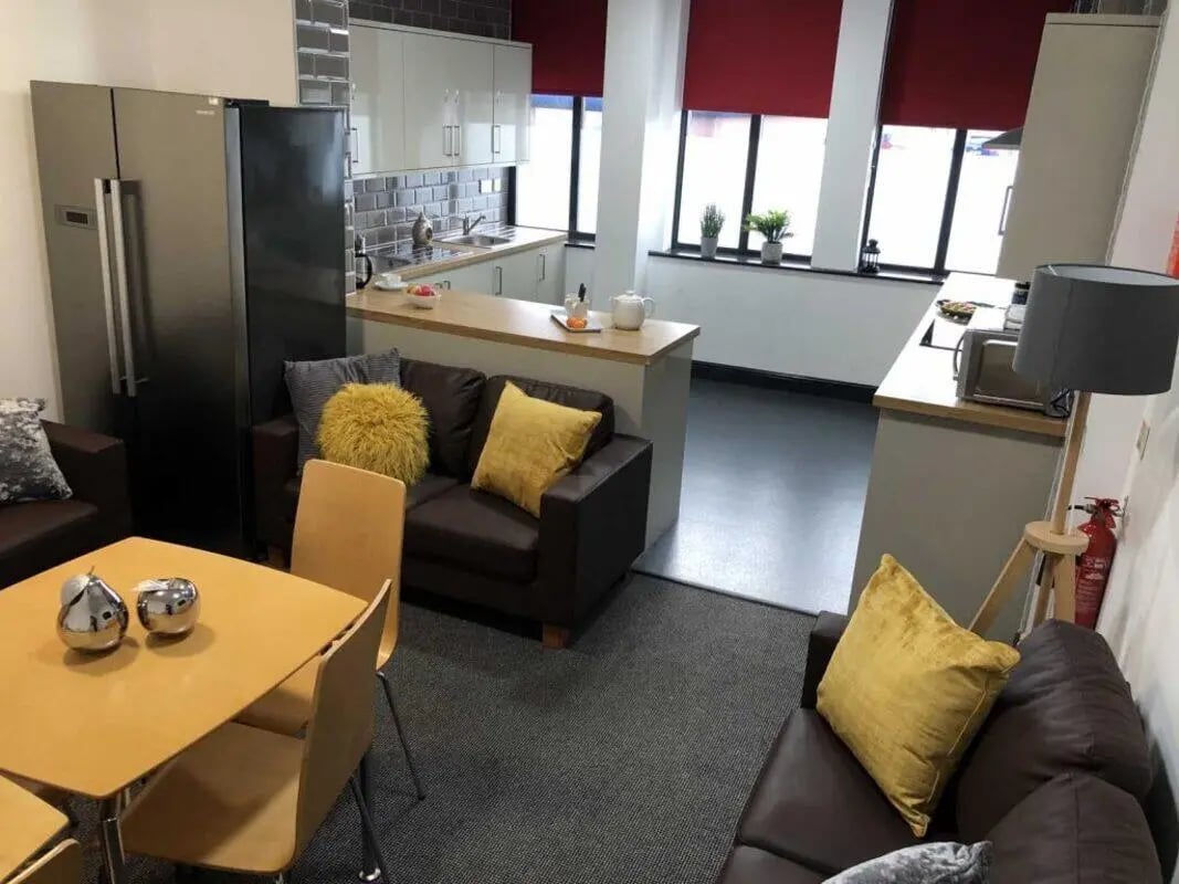 Sofa table fridge kitchen counters living room at Mandale Terrace in Stockton-On-Tees Student Accommodation