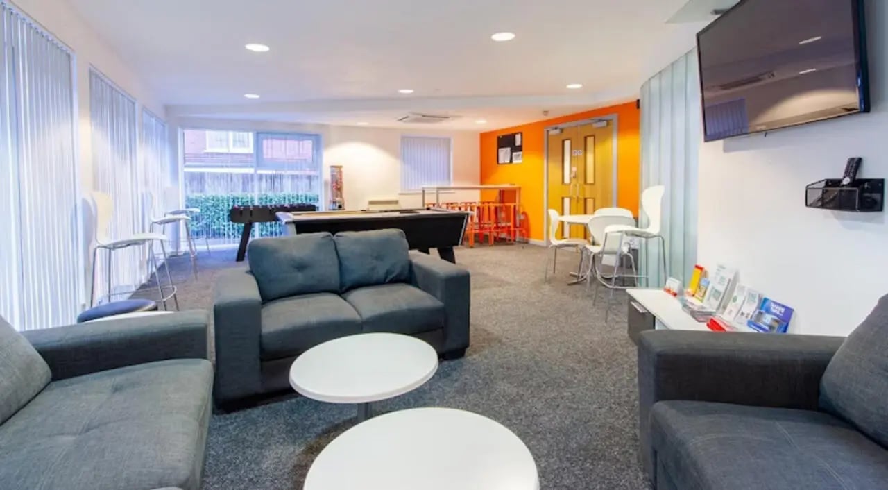 Sofas pool table tables chairs living room at Exeter One in Exeter Student Accommodation