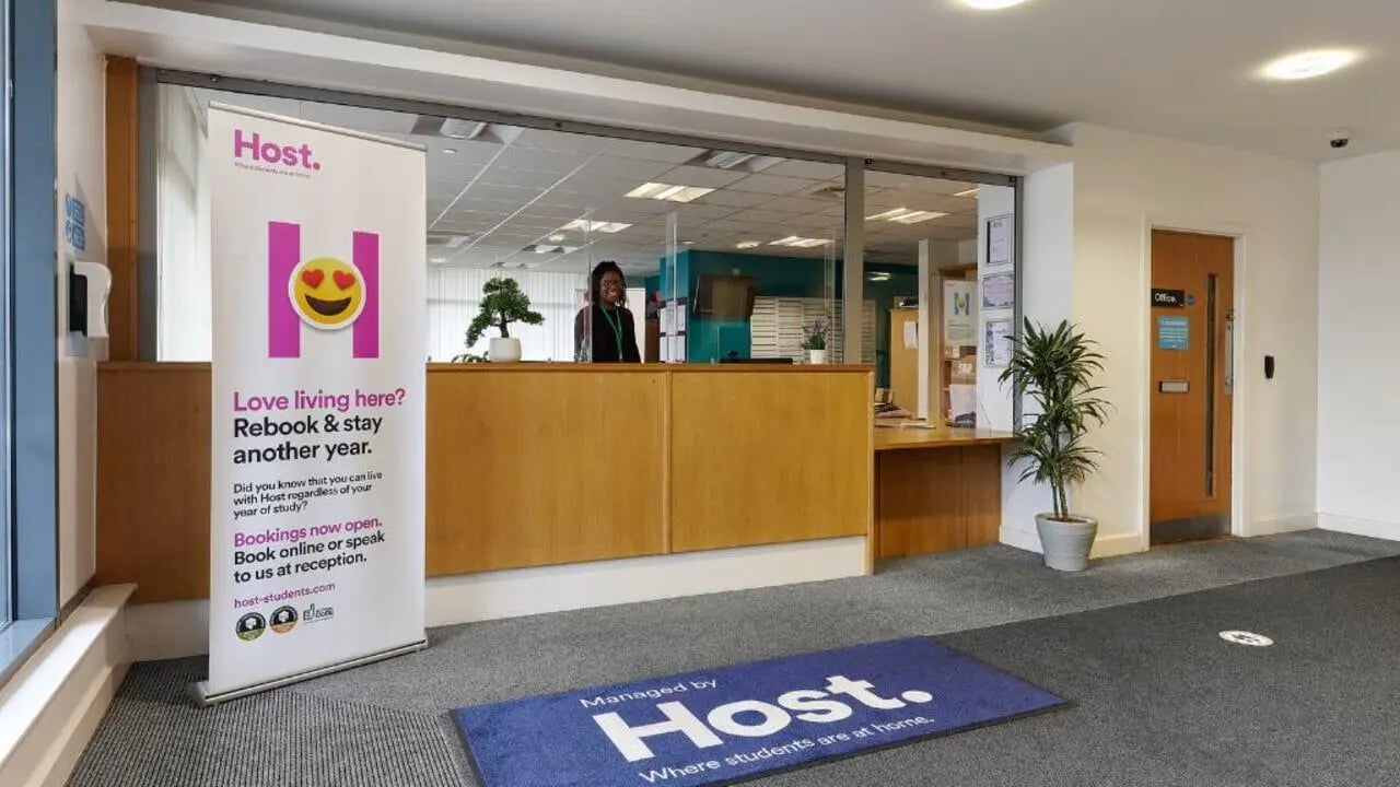 Reception area with staff plant and door at Heantun Point in Wolverhampton Student Accommodation
