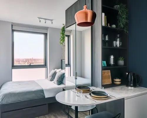 Bed table shelving and kettle studio apartment at ARK Canary Wharf in London Student Accommodation