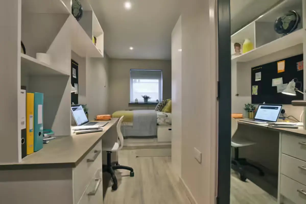 Desks laptops binders bed and window student room. at Clifton Place in Exeter Student Accommodation