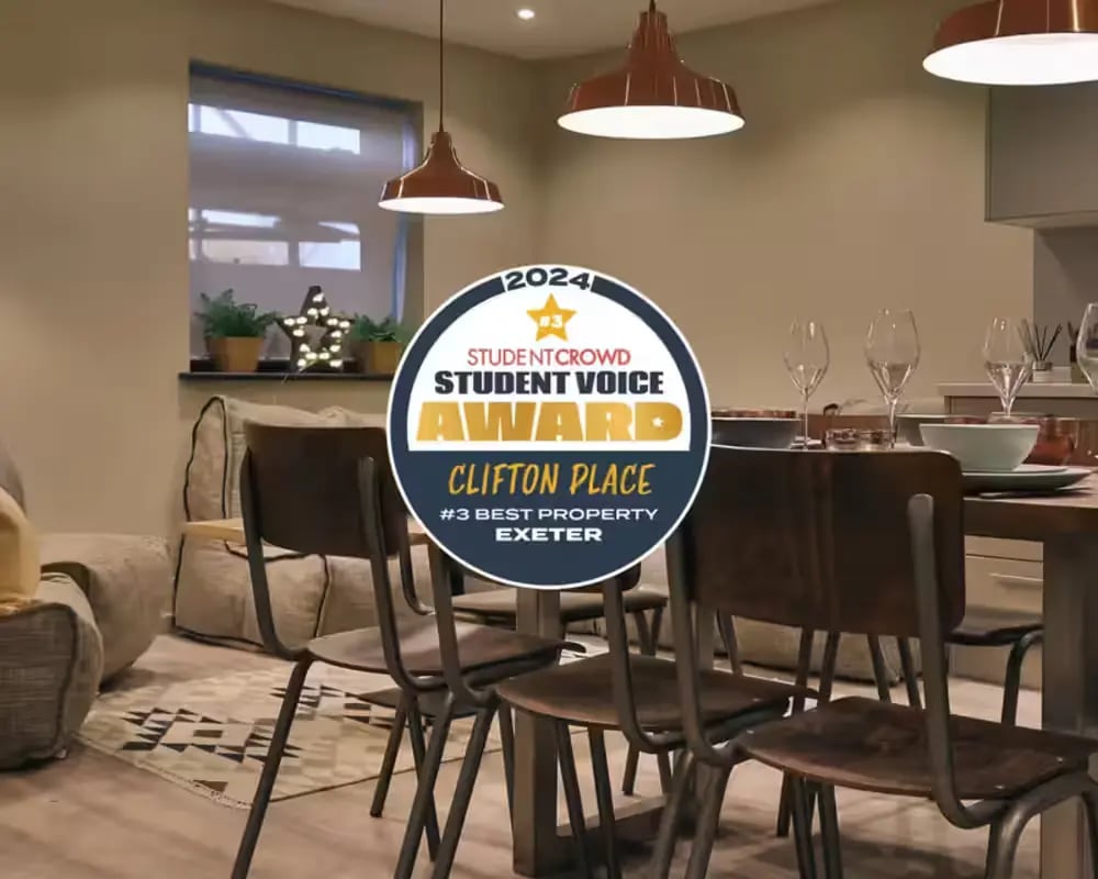 Dining table chairs award badge living area at Clifton Place in Exeter Student Accommodation