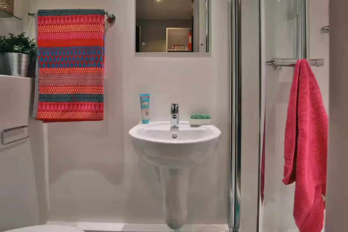 Sink with colorful towel and pink towel Bathroom at Clifton Place in Exeter Student Accommodation
