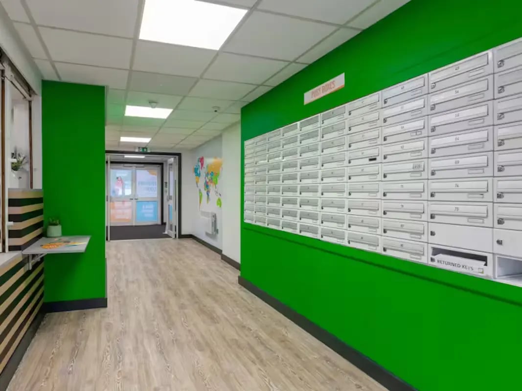 Mailboxes on green wall hallway interior photograph at Foundry Court in Preston Student Accommodation