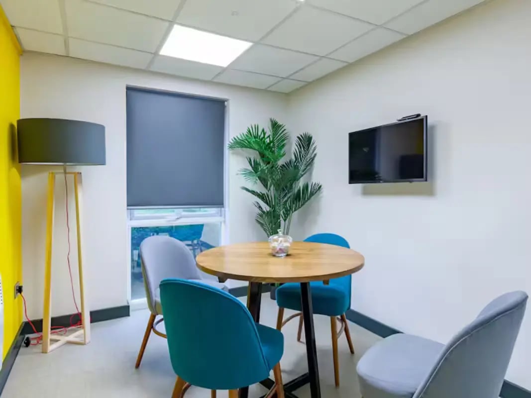 Round table chairs floor lamp television communal area at Foundry Court in Preston Student Accommodation