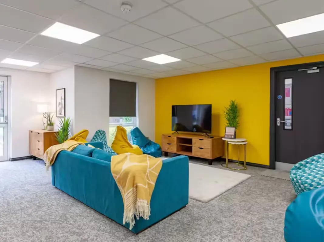 Blue sofa beanbags television rug living room at Foundry Court in Preston Student Accommodation