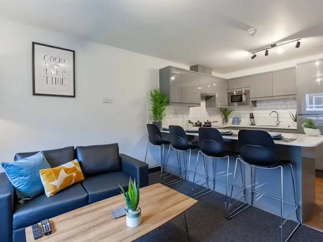 Sofa kitchen island bar stools modern kitchen living area at Foundry Court in Preston Student Accommodation