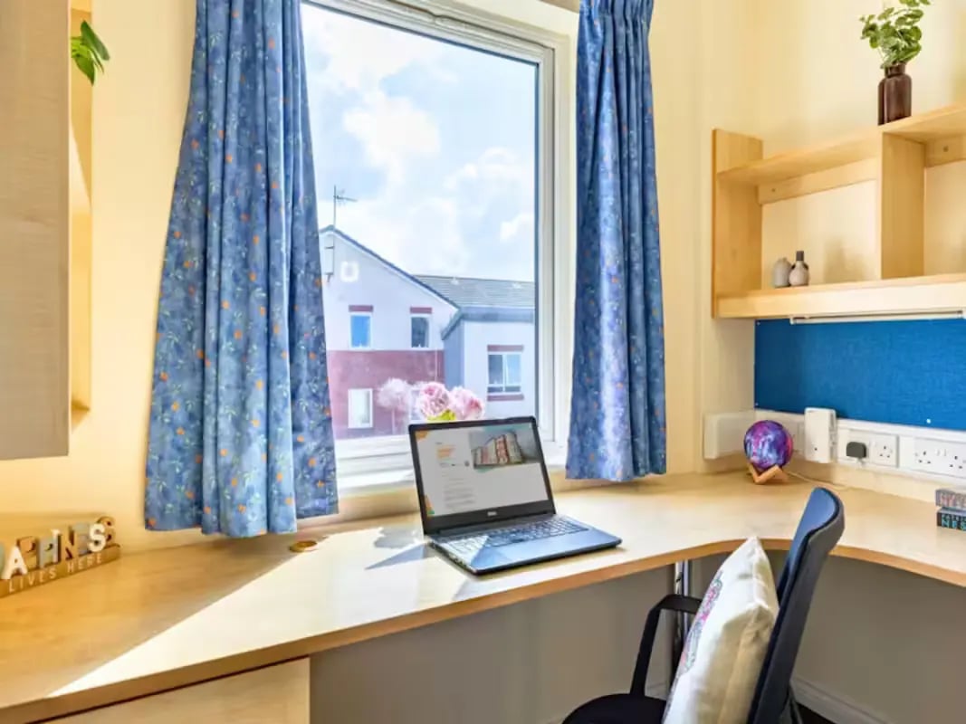 Desk laptop chair curtains window view study area at Foundry Court in Preston Student Accommodation