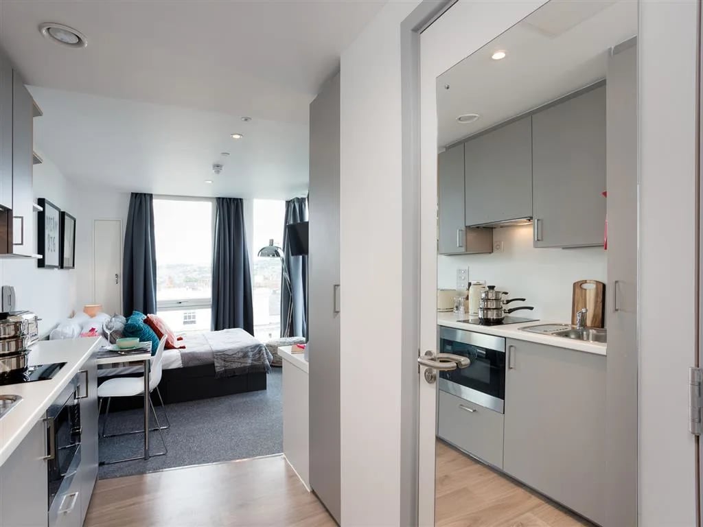 Bed desk and kitchenette interior. at Queen Street Studios in Exeter Student Accommodation