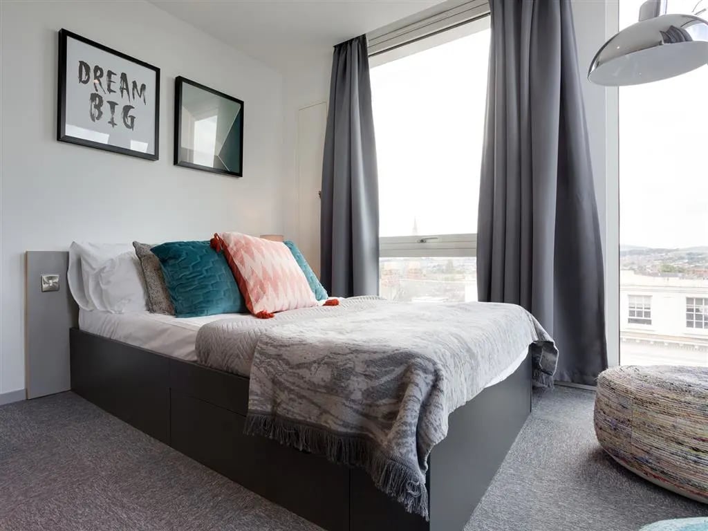 Bed with pillows and framed art bedroom at Queen Street Studios in Exeter Student Accommodation