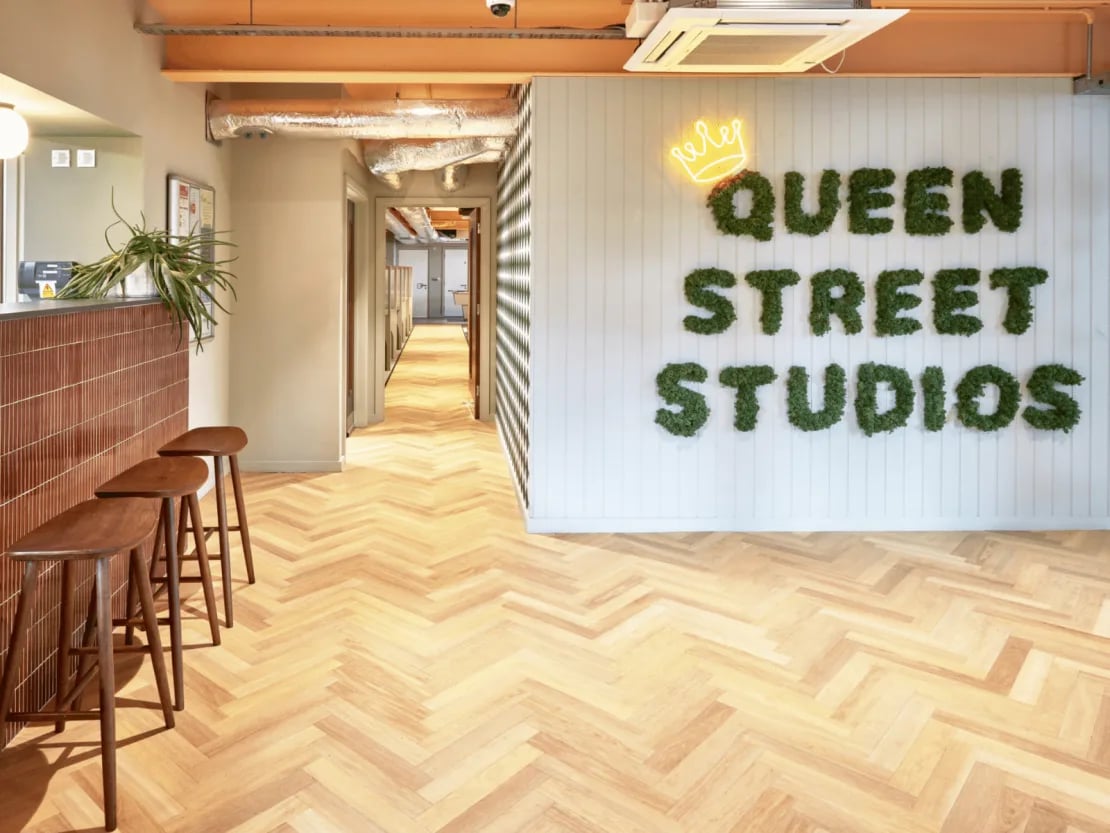 Moss lettering and stools reception area at Queen Street Studios in Exeter Student Accommodation
