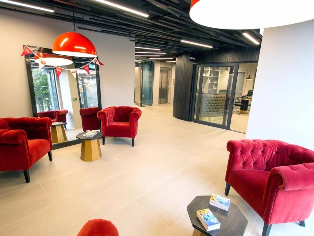 Red velvet armchairs gold mirror reception area lobby at The Shield in Newcastle Upon Tyne Student Accommodation
