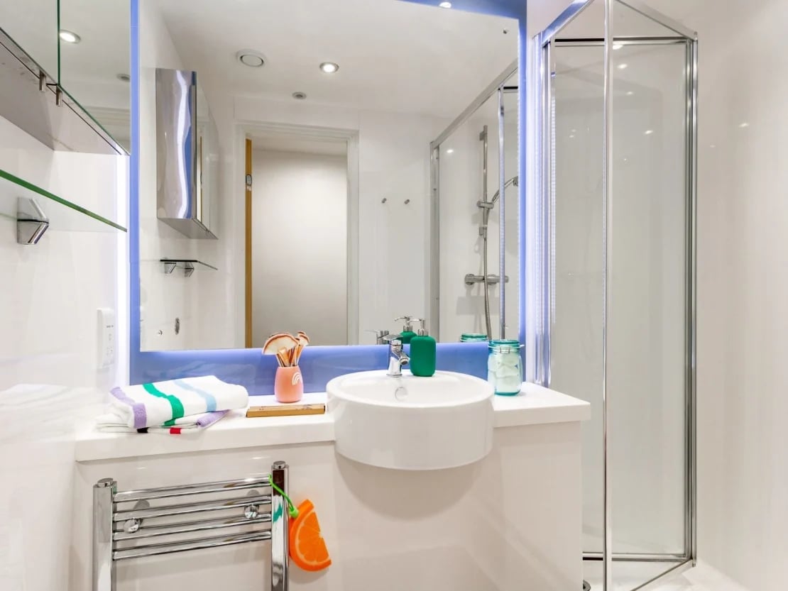 Sink towels makeup brushes shower unit bathroom at The Shield in Newcastle Upon Tyne Student Accommodation