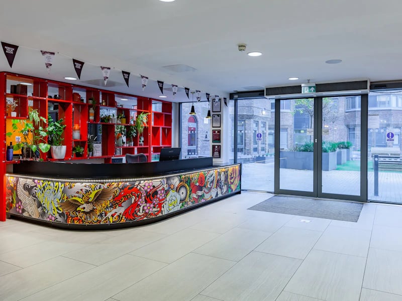 Reception desk with artwork and plants exterior area at The Fitzalan in Cardiff Student Accommodation