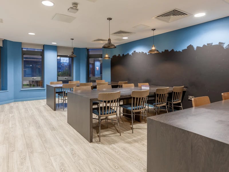 Large tables and chairs in common area at The Fitzalan in Cardiff Student Accommodation