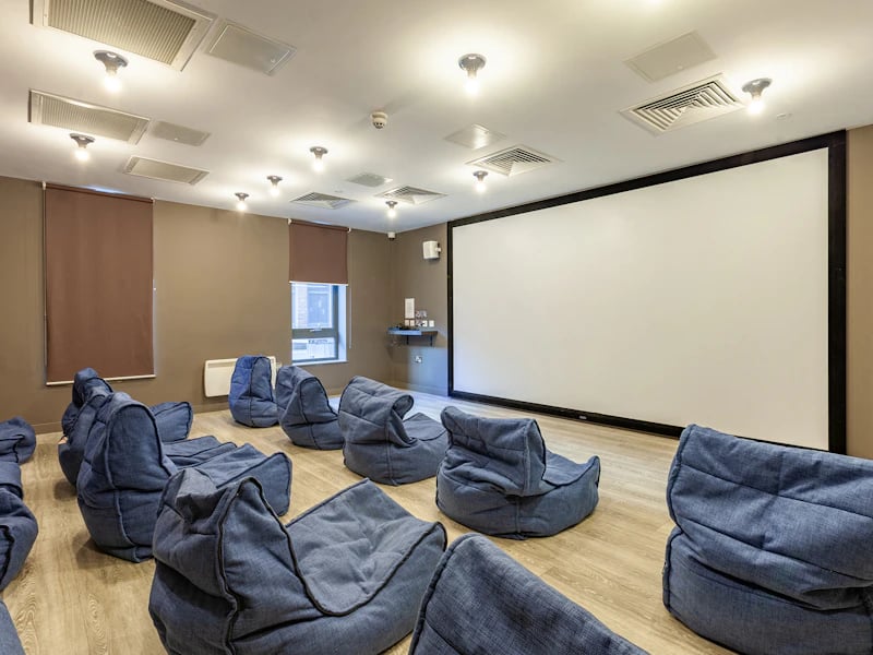 Blue beanbags in front of large projection screen media room at The Fitzalan in Cardiff Student Accommodation