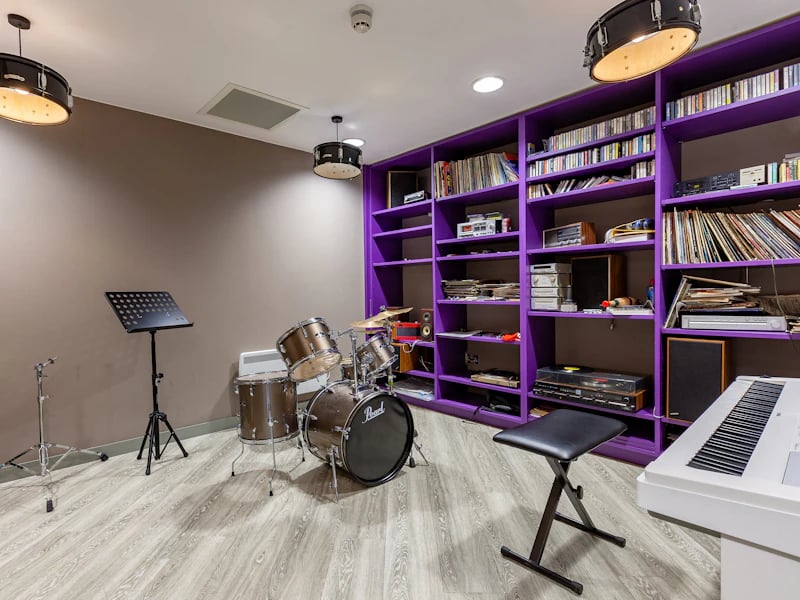 Drum kit music stand purple shelves piano playing area at The Fitzalan in Cardiff Student Accommodation