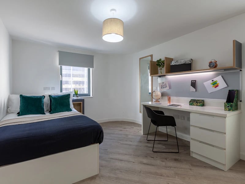Bed desk chair and pillows bedroom at The Fitzalan in Cardiff Student Accommodation