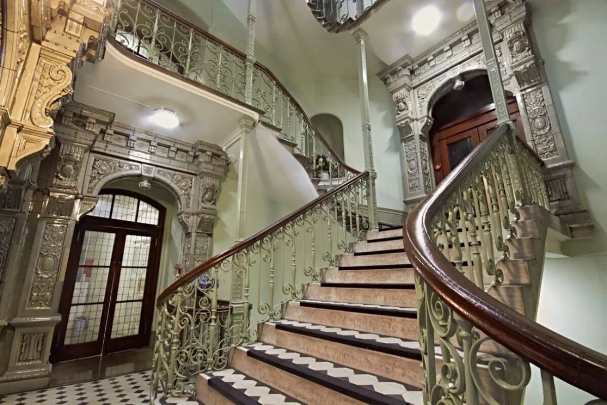 Grand staircase with ornate railings and doors exterior at Queen Alexandra's House in London Student Accommodation