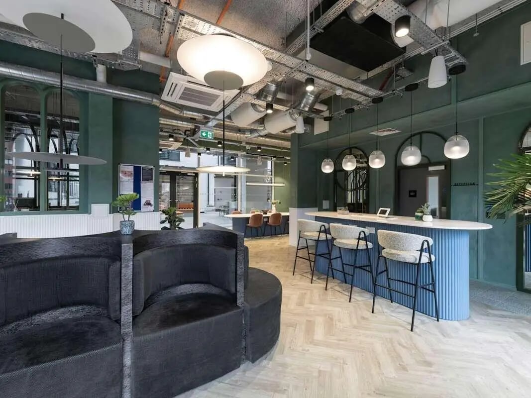 Dark sofa with counter seating and bar stools communal area at Alma Place in Belfast Student Accommodation