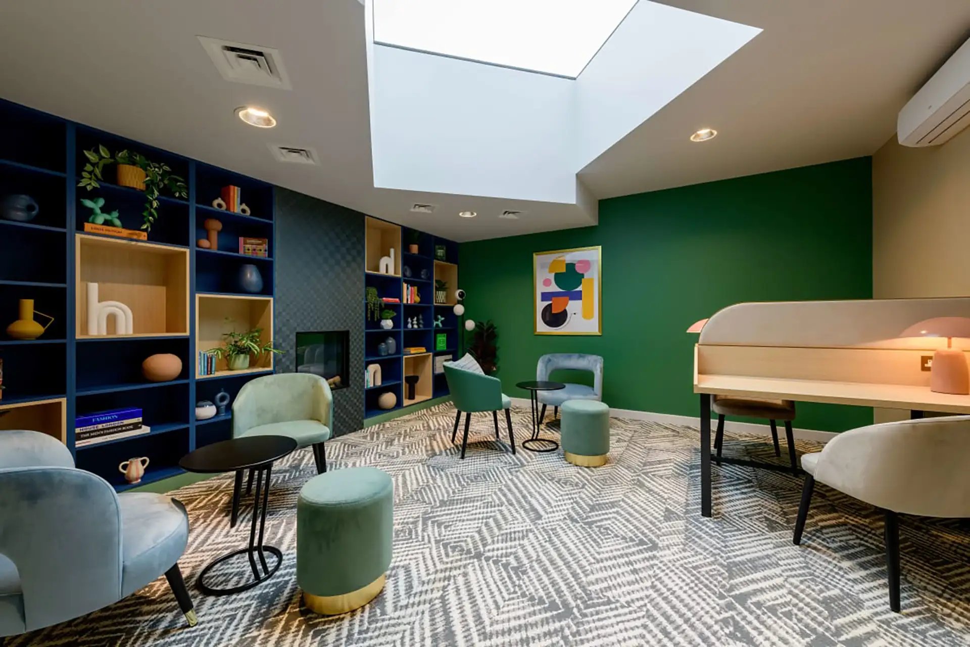 Blue shelves green walls chairs desk living room at Wick Park in London Student Accommodation