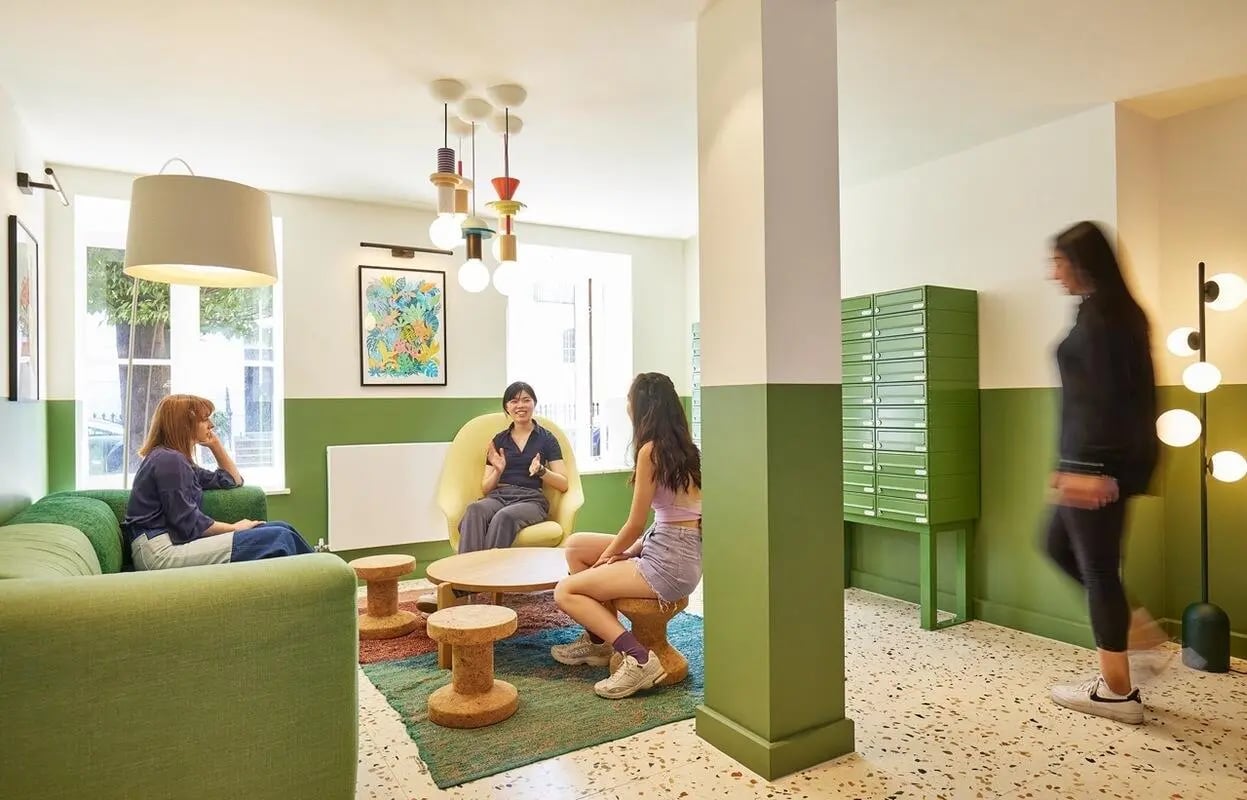Sofa chairs tables and lockers common area at Scape Kings Cross in London Student Accommodation