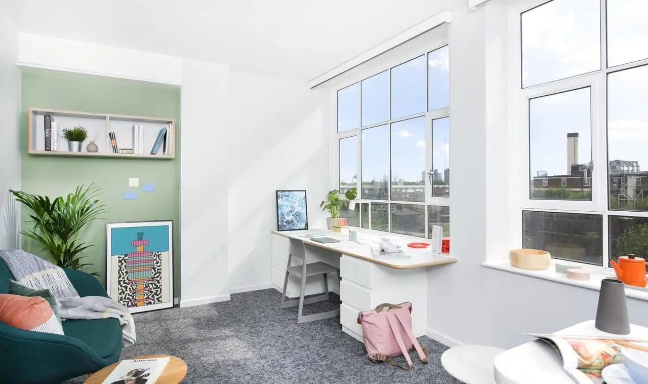 Desk chair plant and pink backpack study area at Scape Kings Cross in London Student Accommodation