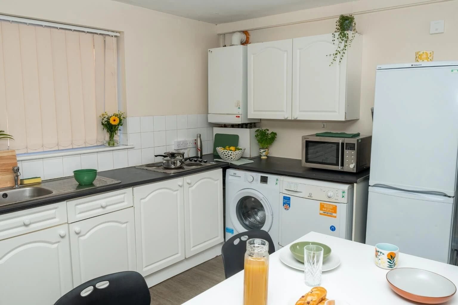 Sink washing machine microwave fridge kitchen at Grange Court & The Ridings in Ormskirk Student Accommodation