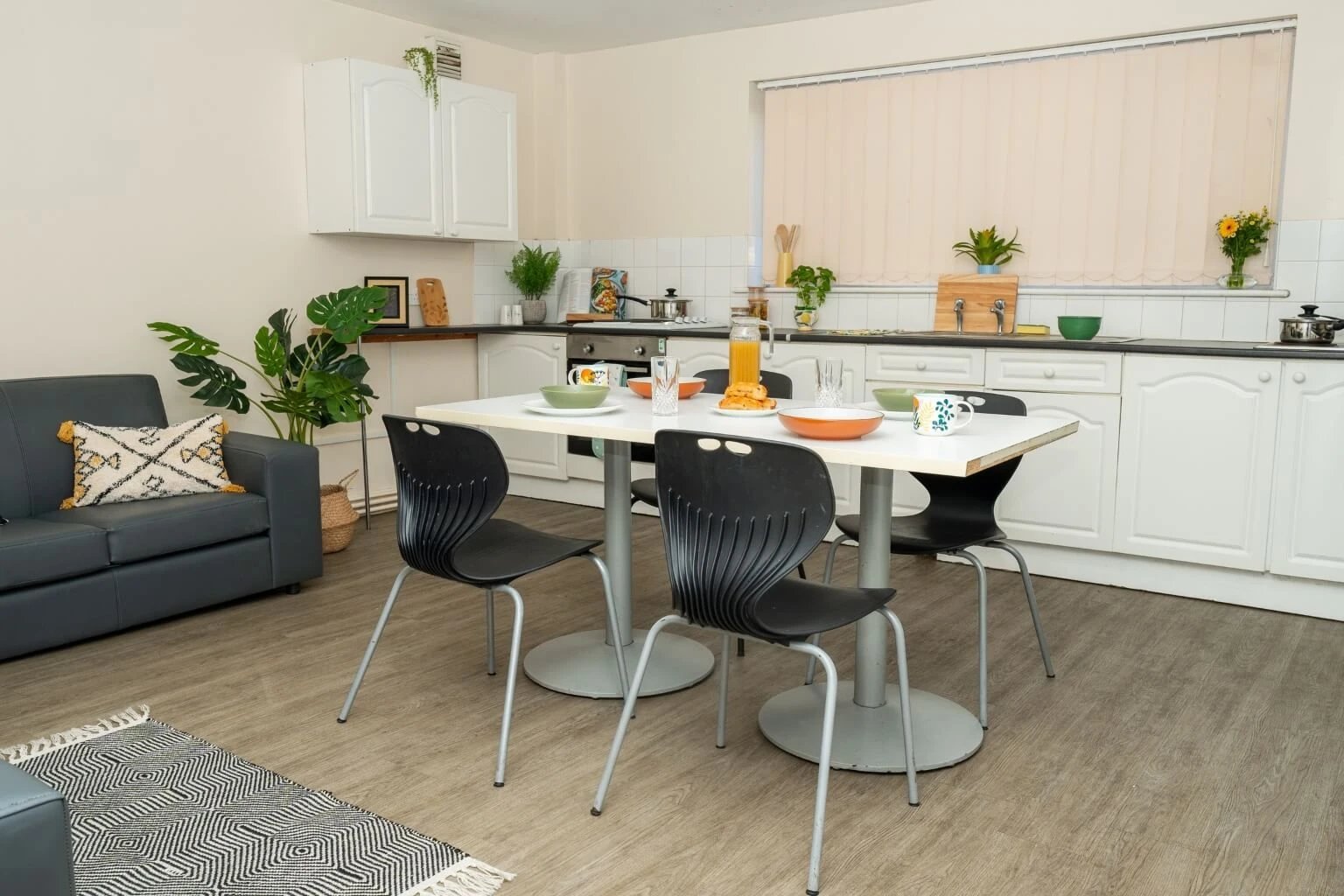 Sofa table chairs plants and kitchen area living kitchen at Grange Court & The Ridings in Ormskirk Student Accommodation