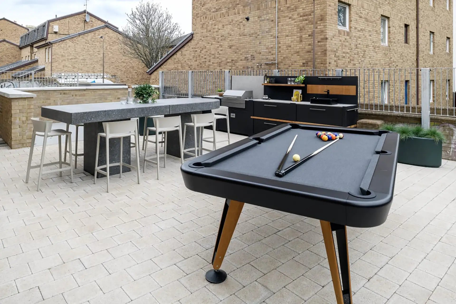 Pool table outdoor kitchen bar seating exterior at Huxley Studios in Edinburgh Student Accommodation