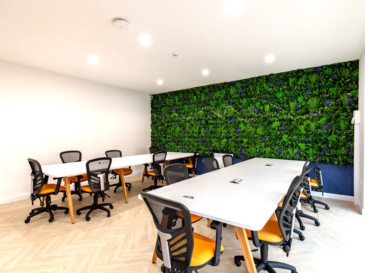 White tables with orange chairs study area at The Leather Works in Leeds Student Accommodation