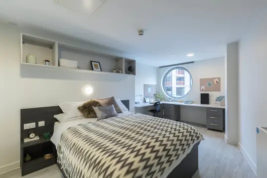Bed desk shelves round window bedroom at Livin Cardiff in Cardiff Student Accommodation