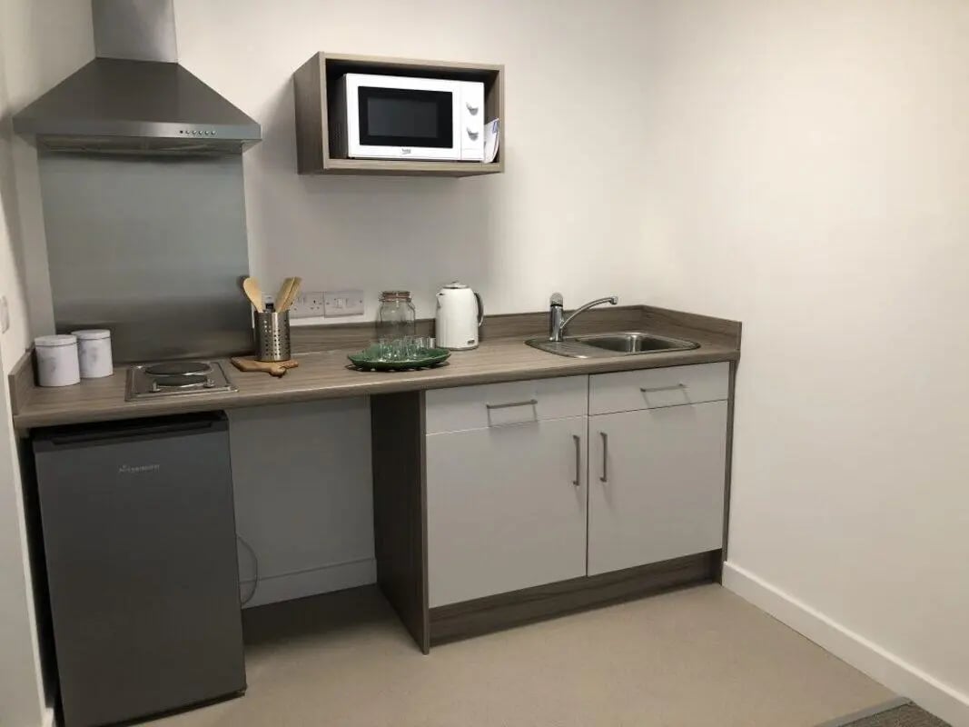 Countertop with sink microwave hob and fridge kitchen at Q Studios in Stoke-On-Trent Student Accommodation
