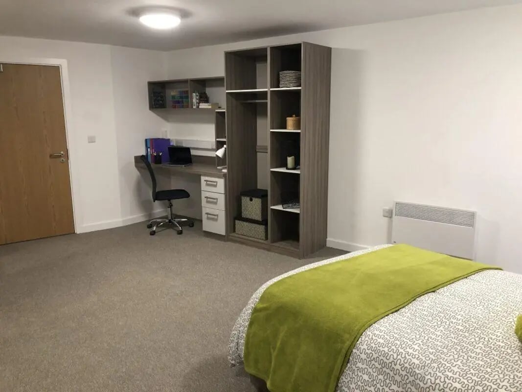 Bed desk wardrobe and shelves bedroom at Q Studios in Stoke-On-Trent Student Accommodation
