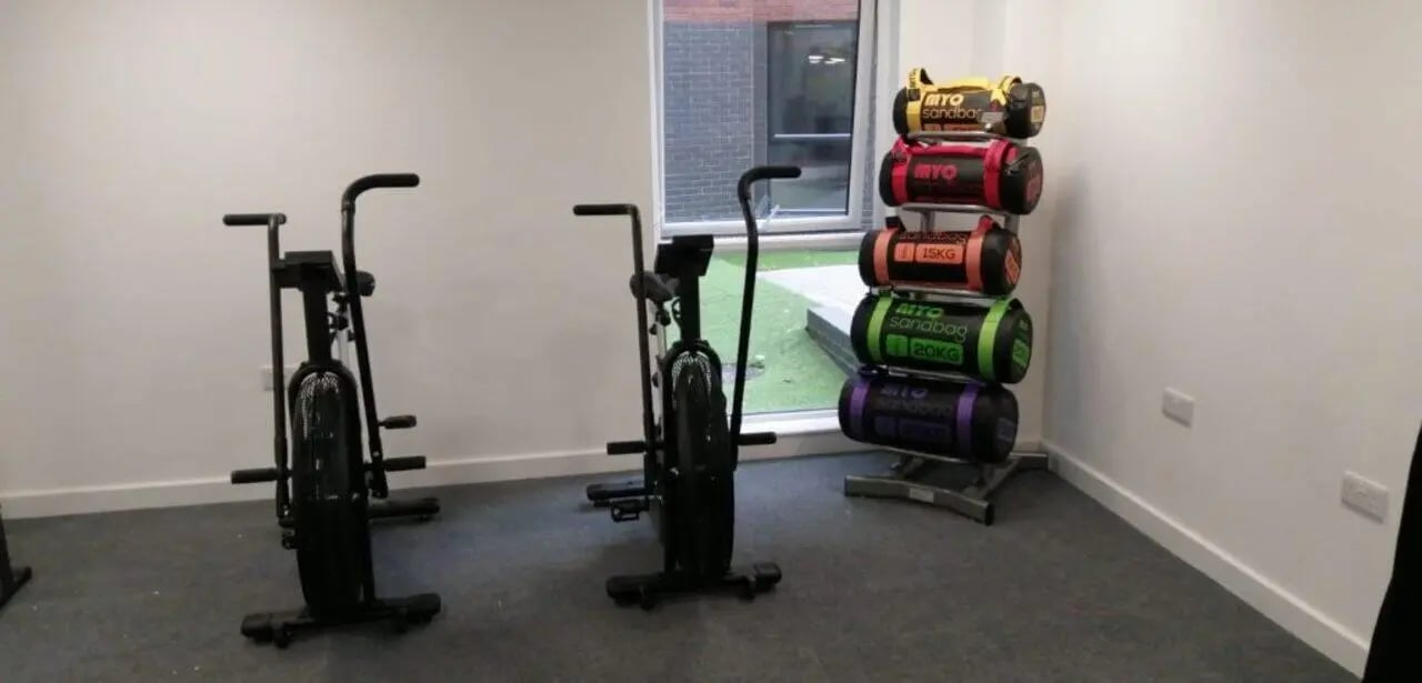 Two air bikes sandbags gym area at Q Studios in Stoke-On-Trent Student Accommodation