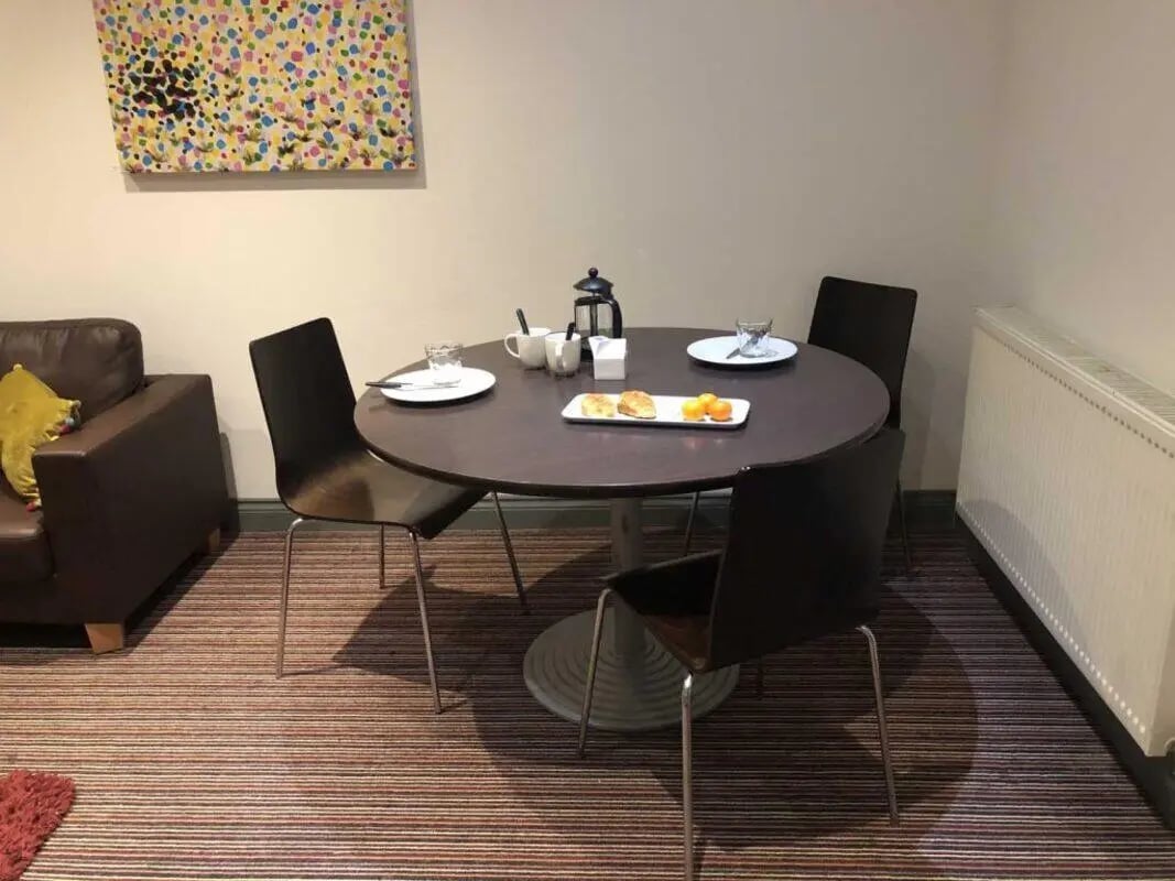 Round table with chairs and artwork living room at Norflok Street in Sunderland Student Accommodation